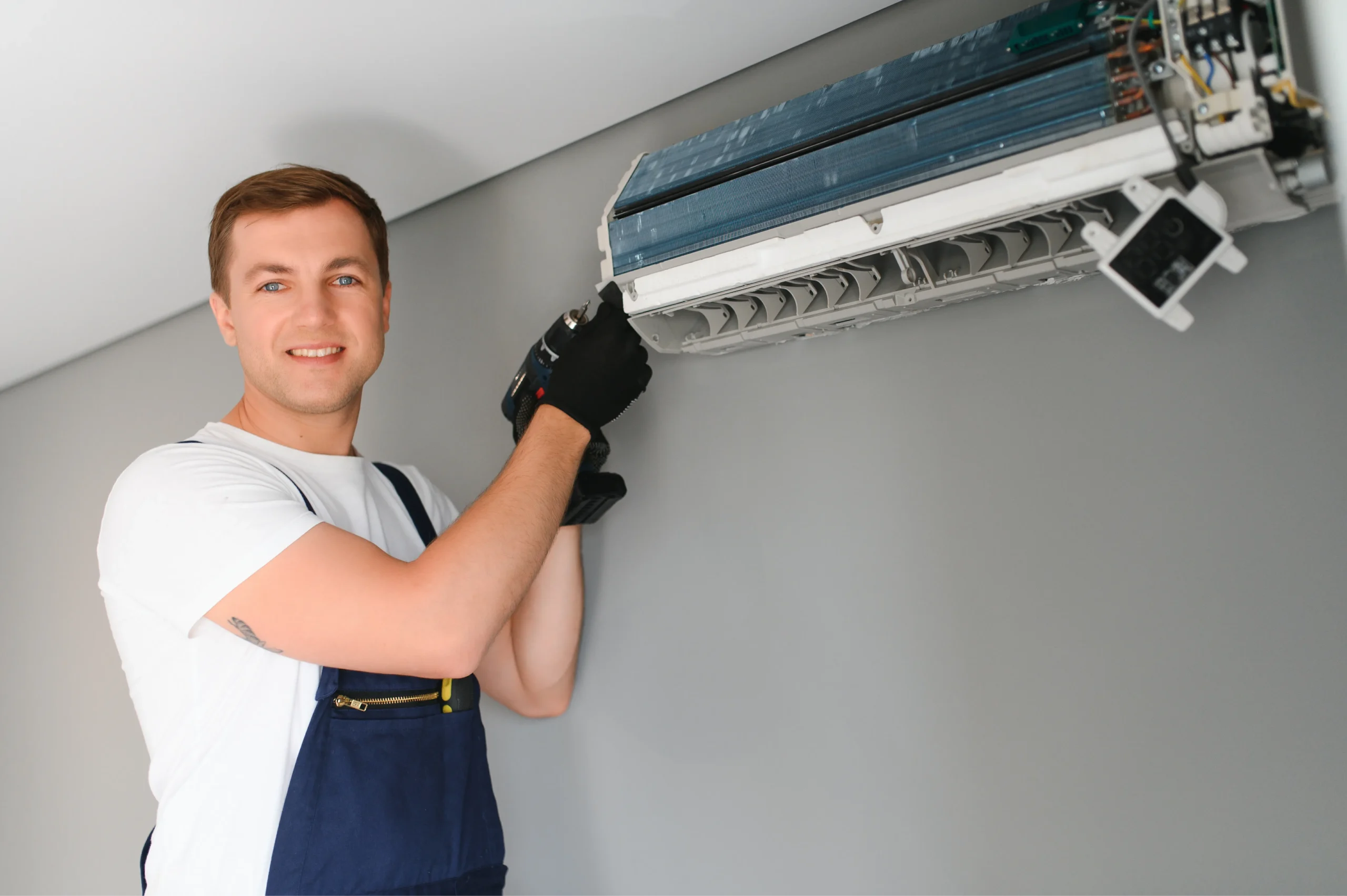 male technician fixing air conditioner indoors photo 1